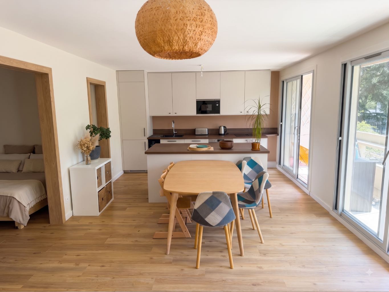 Nos Réalisations 4 Vaste pièce de vie avec cuisine ouverte et îlot central, résultat de la restructuration d'un appartement familial de 96m² au Point du Jour (Lyon 5).